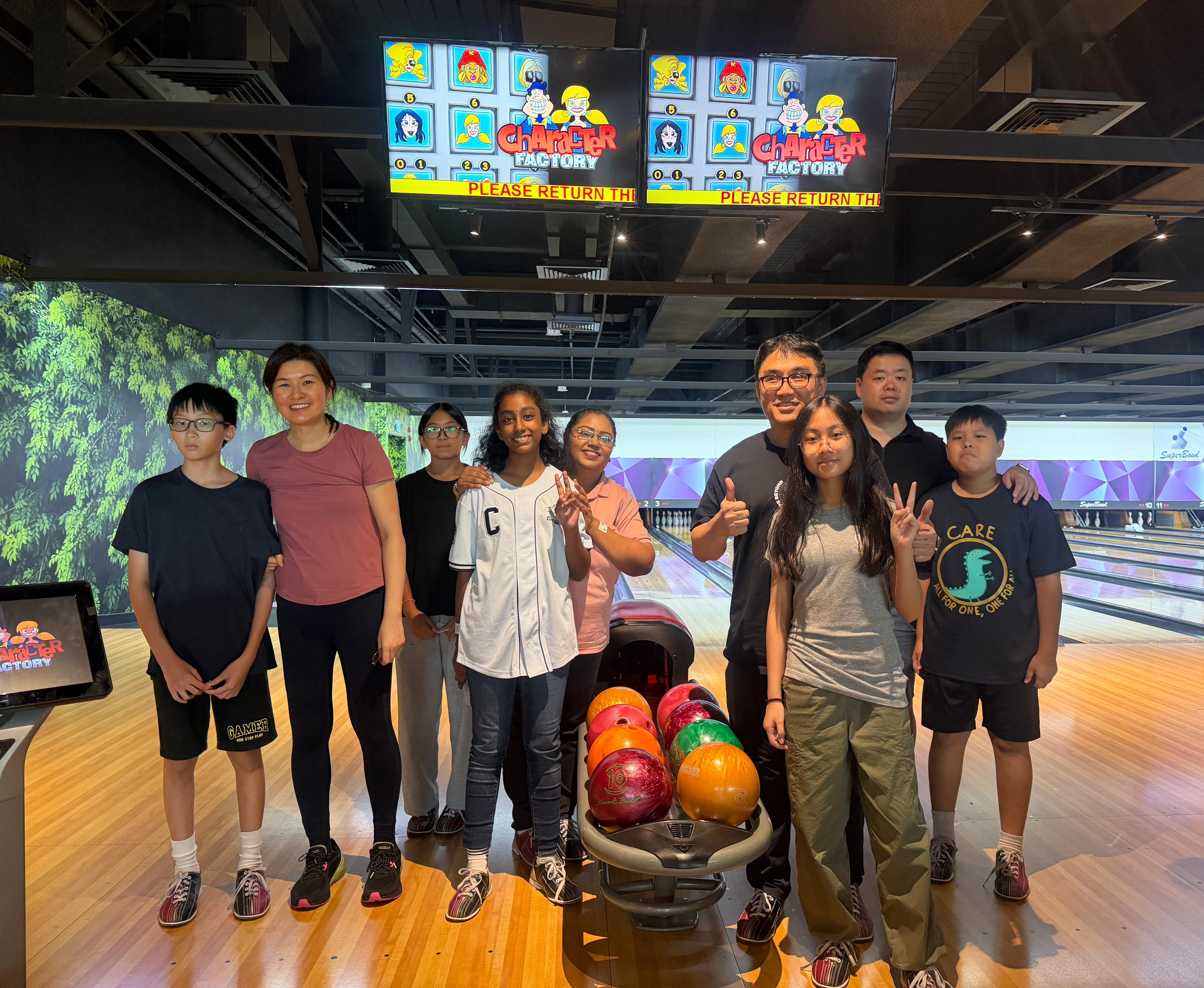 A group of parents with their child during a bowling bonding session
